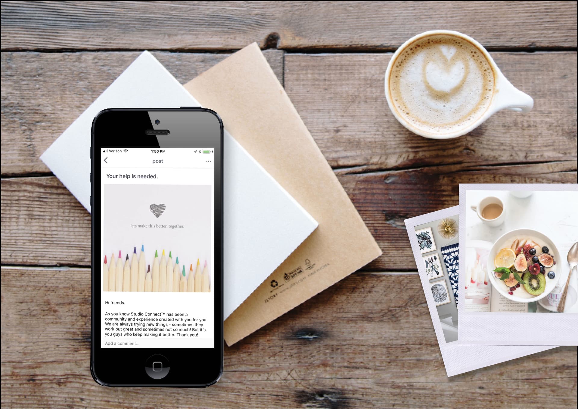 Photo of mobile phone app, coffee in a cup, and photos on a wood table